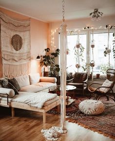 a living room filled with furniture and lots of plants