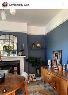 a living room filled with furniture and a fire place next to a table in front of a fireplace