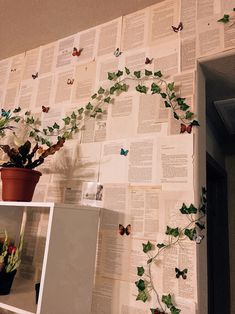 there is a potted plant on top of a shelf next to a book page wall