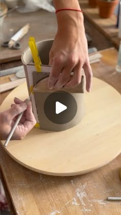 two people are working on something in a bowl