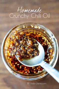 homemade crunchy chili oil in a glass jar with a spoon on the side and text overlay that reads homemade crunchy chili oil