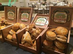 several wooden boxes filled with pastries on top of a table