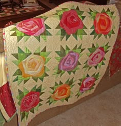 an image of a flower quilt on the facebook page for love sewing and quilting