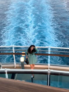 a woman standing on the deck of a boat