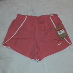 Coral Pink With White Trim Dri-Fit Inside Tie, Pocket And Lining Pink Athletic Shorts For Spring Workout, Pink Sports Shorts For Spring, Pink Nike Athletic Shorts For Spring, Spring Nike Pink Athletic Shorts, Nike Pink Athletic Shorts For Spring, Nike Pink Athletic Shorts For Summer, Pink Sporty Shorts For Spring, Sporty Pink Athletic Shorts For Beach, Sporty Pink Shorts For Spring