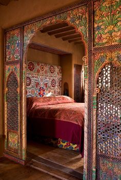 an ornately decorated bedroom with mirrored doors