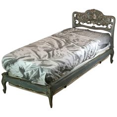 an antique style bed with metal headboard and foot board