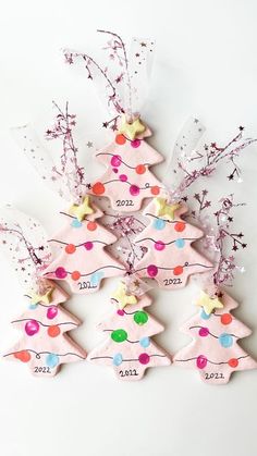 pink christmas tree ornaments with stars and confetti on the top one is numbered for 2012