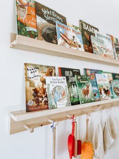 there are many books on the shelves in this children's book shelf, along with toys