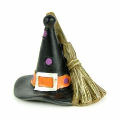 a small witch hat with a broom on it