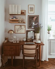 a wooden desk sitting next to a window