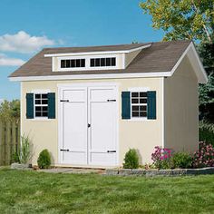 an image of a small storage shed in the yard with grass and flowers around it