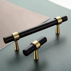 two black and gold poles on top of a table