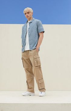 Experience ultimate versatility and durability with PacSun's Tan Baggy Cargo Zip-Off Pants. Crafted from cotton with a drawstring waistline, these pants boast ample storage with side and cargo pockets, while offering the convenience of zip-off legs for instant shorts transformation. Finished with additional cargo pockets near the hem, they ensure both style and functionality for your adventurous outings. Tapered Cargo Pants Men, Cargo Brown Pants Outfit, Men Cargo Pants Outfit Fashion, Baggy Jeans For Boys, Tan Cargo Pants Outfit Men, White Cargo Pants Outfit Street Styles, Tan Pants Outfit Men, Beige Cargo Pants Outfit Men, Cargo Pants Men Outfit