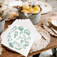 napkins with drawings on them sitting on a table next to other dishes and utensils