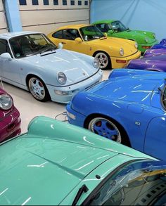 many different colored cars parked in a garage