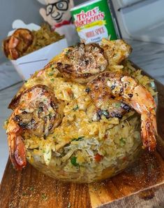 shrimp and rice dish served on wooden platter with stuffed animal in the back ground