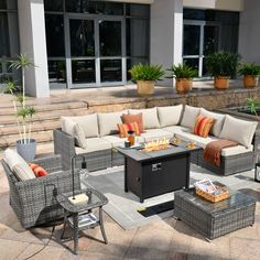 an outdoor living area with wicker furniture and potted plants