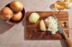 an onion and onions on a cutting board next to a knife