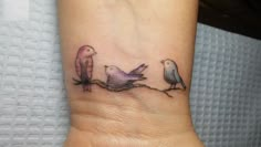 two birds on a branch tattoo on the wrist