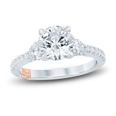 a diamond engagement ring with two stones on the side and an accent band around it