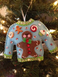 a christmas ornament hanging from a tree in the shape of a gingerbread man