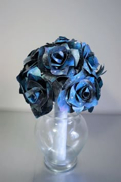 a vase filled with blue flowers on top of a table