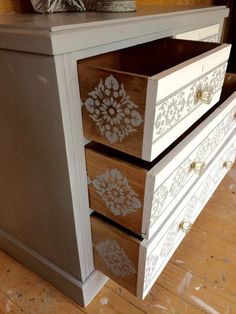 an old dresser has been painted with stencils