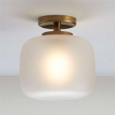 a light fixture with a white glass shade