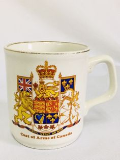 a coffee cup with the coat of arms of canada on it