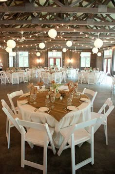 an image of a room with tables and chairs set up for a formal function or party