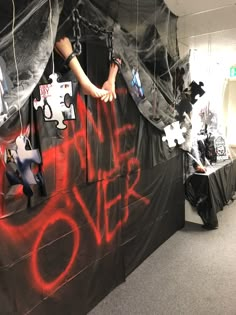 a man climbing up the side of a wall covered in graffiti