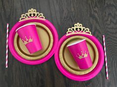 two paper plates with pink cups on them