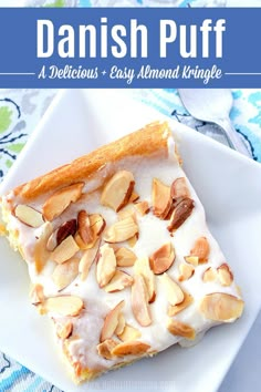 a white plate topped with cake covered in almonds