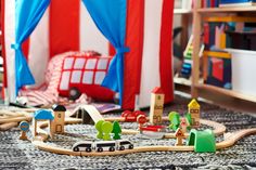 a toy train set sitting on top of a rug