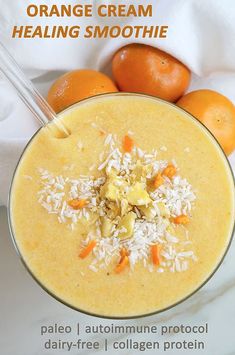 an orange cream smoothie in a glass bowl with coconut flakes on the rim