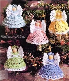 crocheted angel ornaments hanging from a christmas tree