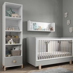 a baby's room with a white crib and shelves