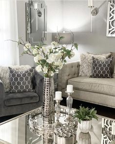 a living room with two couches and a coffee table in front of a mirror