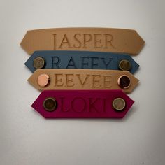 three different colored tags with the words laser, raeve and loki on them