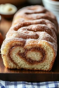 a cinnamon roll sitting on top of a wooden cutting board