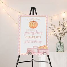 a welcome sign for a little pumpkin charlie's first birthday on an easel