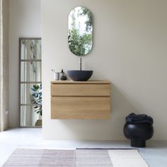 a bathroom with a sink, mirror and rug