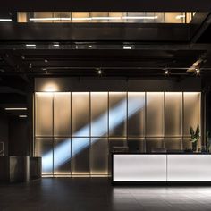 an empty lobby with a white reception counter