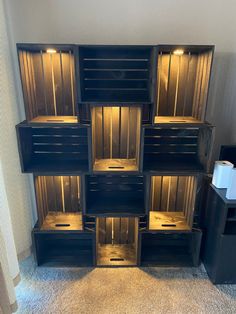 a stack of wooden crates sitting on top of a carpeted floor