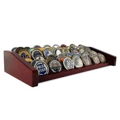 a wooden display case filled with lots of different types of beer caps and magnets