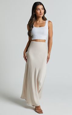 Get ready to turn heads in the Amari Midi Skirt! This high-waisted bias cut skirt in oyster is the perfect blend of casual and chic. Made from soft polyester, this slip skirt will feel as good as it looks. With its cream color and midi length, it's a versatile piece that can be dressed up or down for any occasion. Whether you're heading to brunch with friends or stepping out for a night on the town, this flirty skirt will have you feeling fabulous all day long. So go ahead, add a touch of elegan Cropped Knit Top, Runway Outfits, High Waisted Maxi Skirt, Bias Cut Skirt, Neckline Designs, Skirt Midi, Slip Skirt, Brunch Outfit, Knit Crop Top