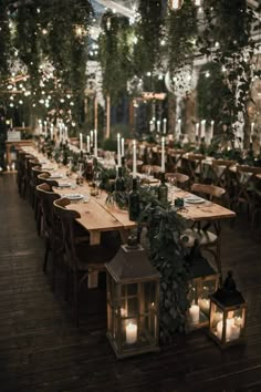 a long table with candles and greenery is set up for an outdoor wedding reception