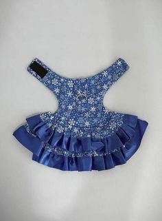 a blue dog dress with white flowers on the collar and ruffles around the waist