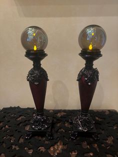 two glass vases sitting on top of a table